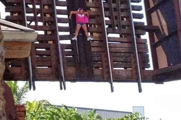 Woman in pink top stuck on lifting railroad