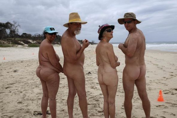 Two couples naked on a nudist beach