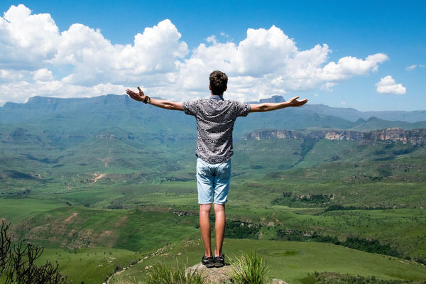 An Adventurous Man Taking In The View Of A Cliff Edge