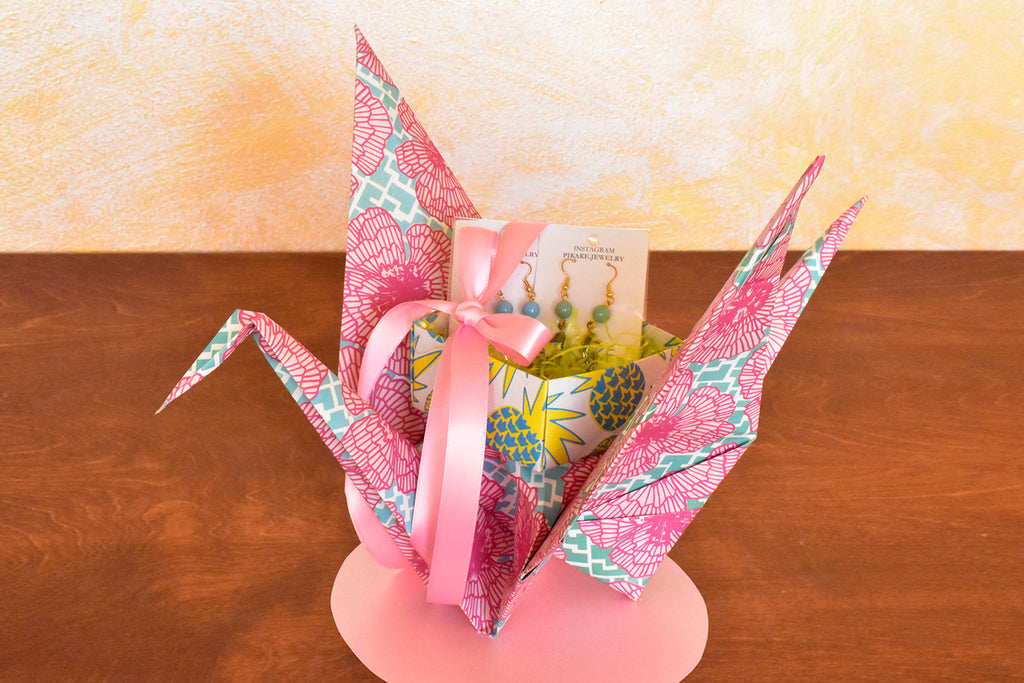 Sweet little gifts arrive on the wings of this elegant origami crane gift wrap designed by Shiho Masuda of Paper Guru.