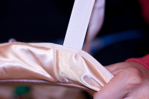 Sewn pointe shoe ribbon outside of shoe