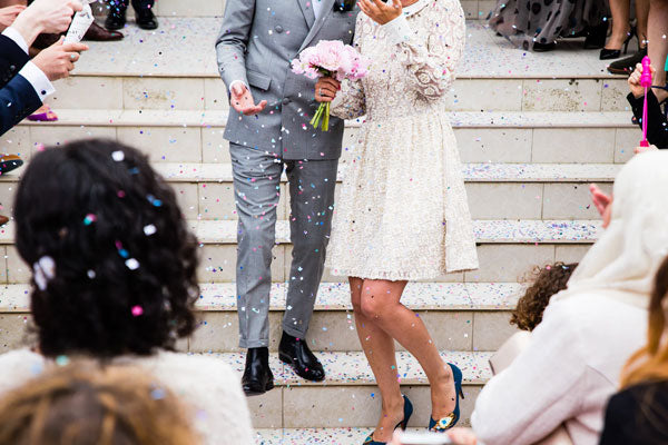 Recently married couple walk down court steps