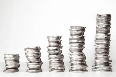 Stacks of silver coins on a white background.