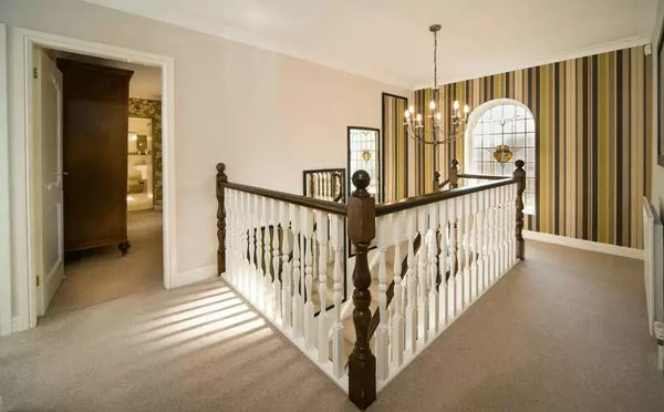 photo of landing with balustrade feature wall pattern stripes wallpaper