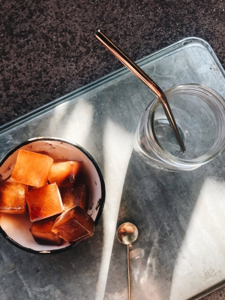Big Heart Tea Co.'s Fake Coffee ice cubes with reusable straw, reusable cup, and golden reusable spoon
