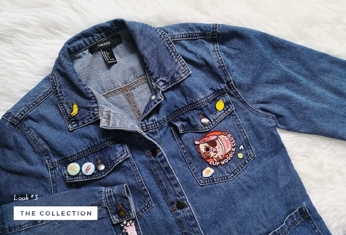 Denim jacket with a collection of food themed enamel pins and patches.