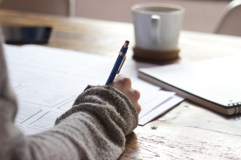 person sitting at table doing work