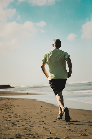 man running along the beach