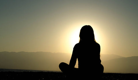 woman sitting at sunset