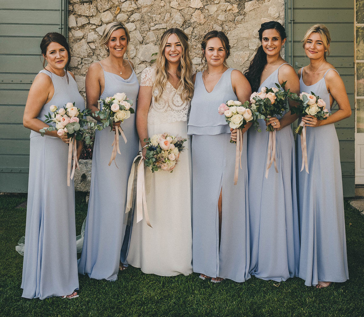 Maddie Chester with her bridemaids. Maddie's bridesmaid were designed and made by us in London to suit her wedding theme colour of light blue.