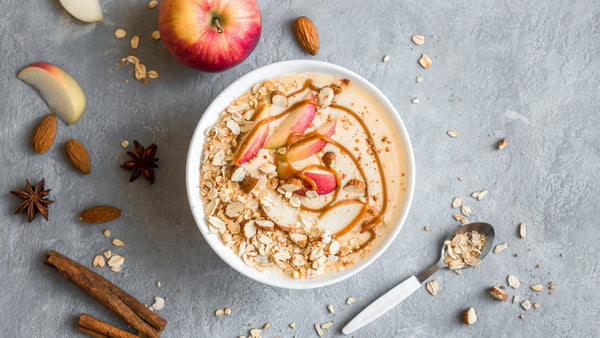 spiced chai smoothie bowl topped with apples and maple syrup
