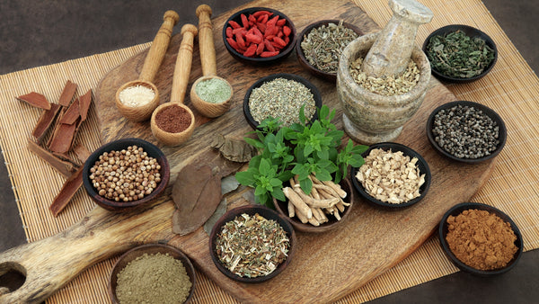 variety of loose ayurvedic spices in bowls and spoons