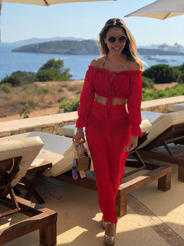 Youma Leth at Ibiza wearing red top and trousers