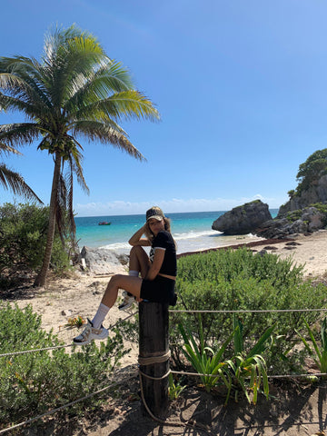 Youma Leth near the beach of Tulum Mexico wearing black outfits