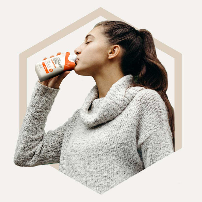 Woman drinking Bulletproof Coffee Cold Brew with Collagen Protein