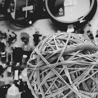 A picture of a community rubber band ball in Bikeland's bike repair shop, that represents our bond with the community.