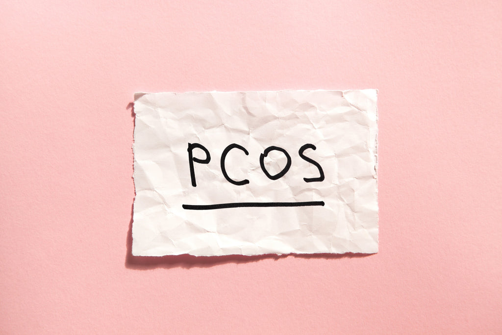 Scrunched up paper with PCOS written on