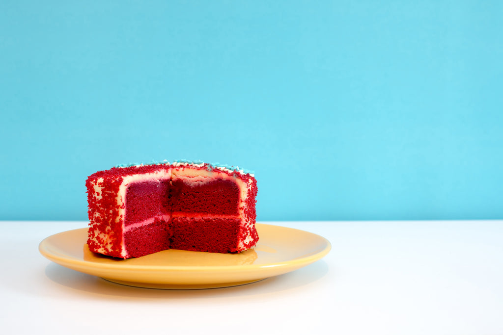 Red velvet cake with a slice missing 