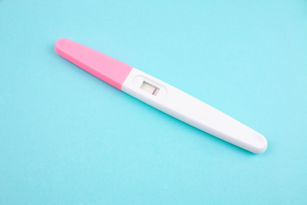 Negative pregnancy test on blue background 