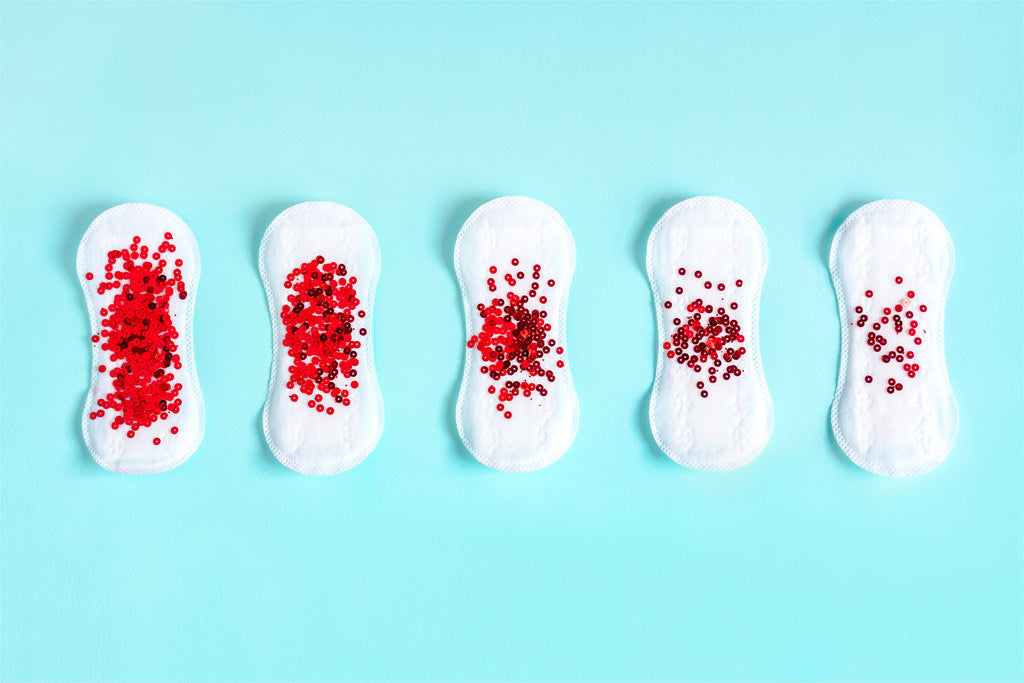 A line of sanitary towels with red sequins on
