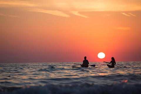 sunset paddle boarding