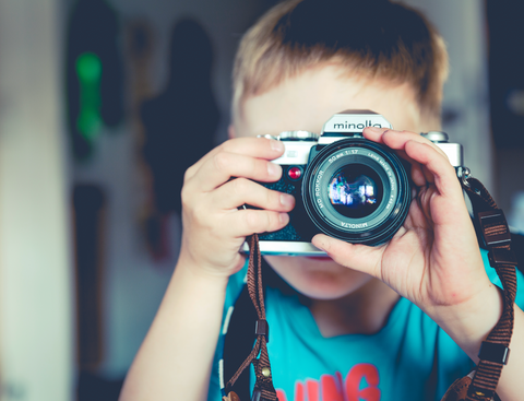 photo of boy with film camera
