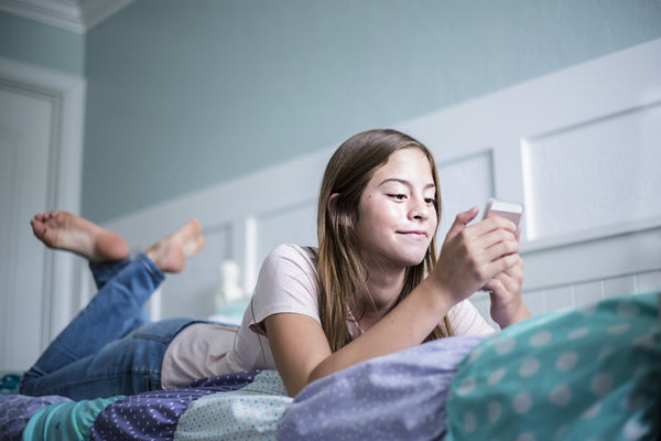 Girl on bed with phone