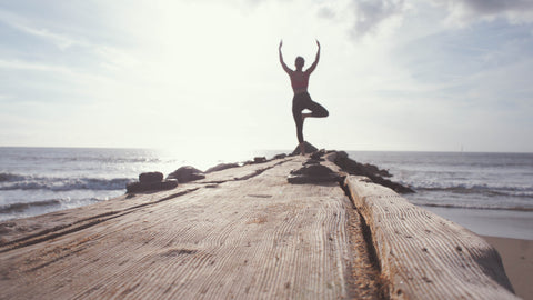woman doing yoga on dock