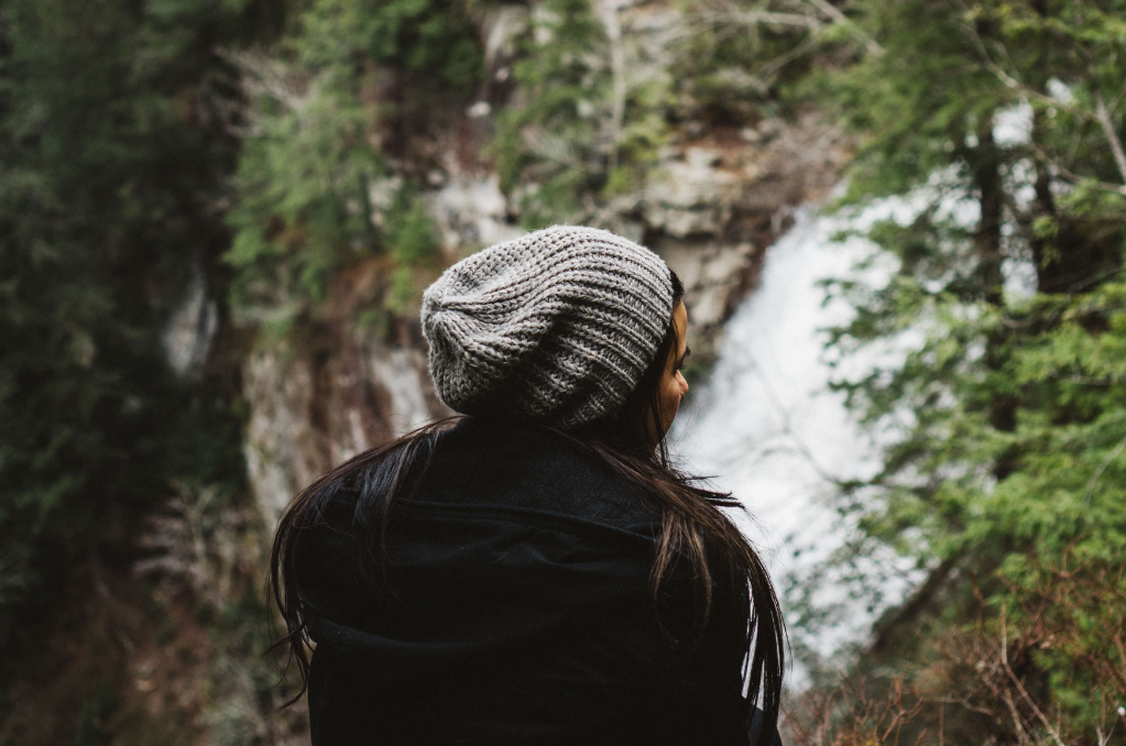 Woman wearing a knitted beanie overlooking waterfalls