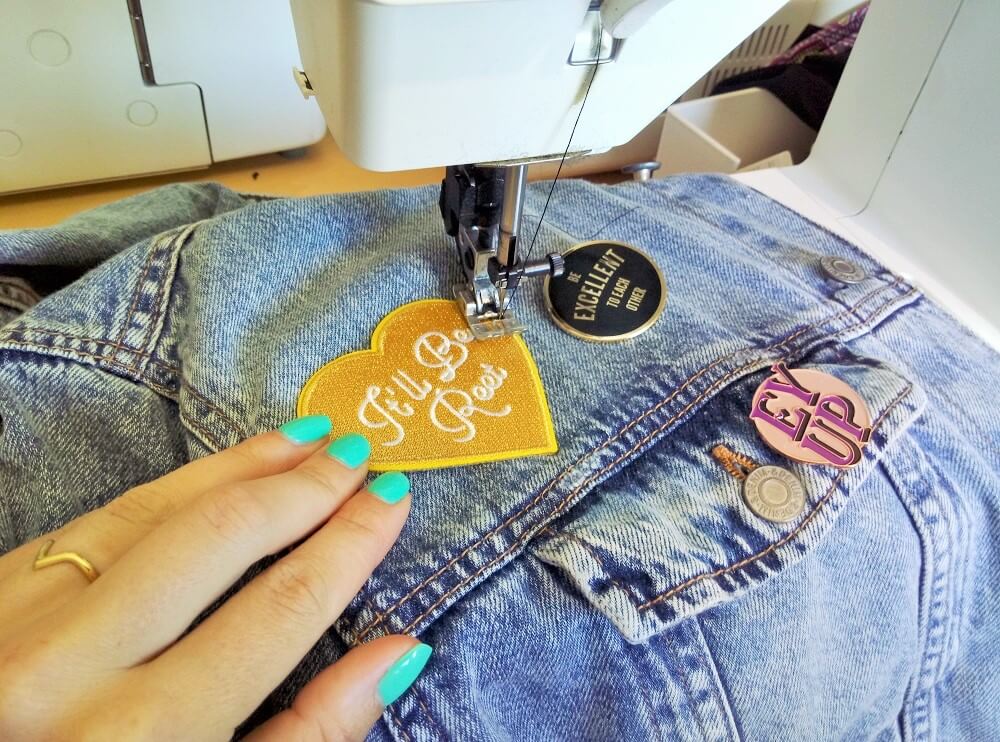 Sewing a patch on to a denim jacket