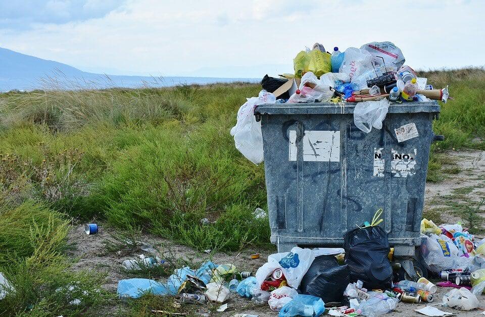 Overflowing dumpster full of plastic waste