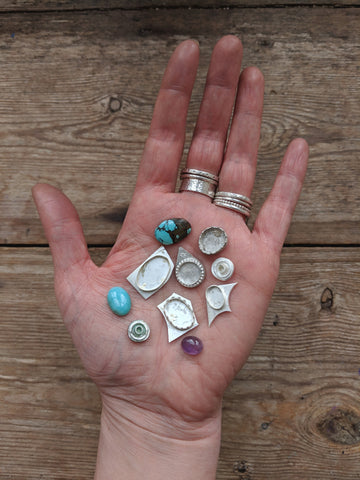 hand full of cabochons and settings in sterling silver