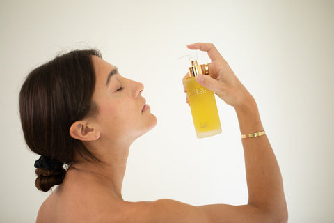 Brunette Woman Applying Liquid Gold Cleansing Face Oil 