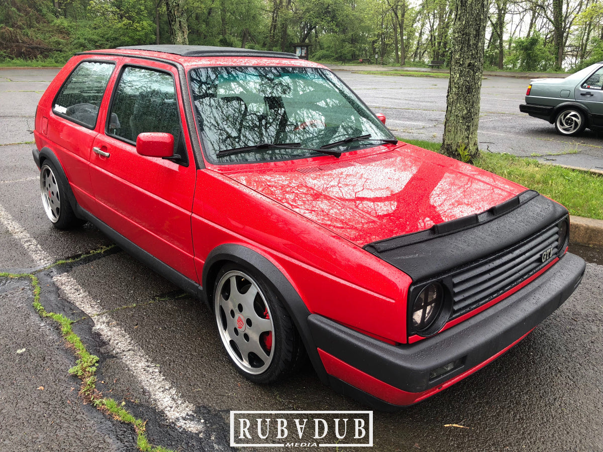 red mk2 golf on porsche d90