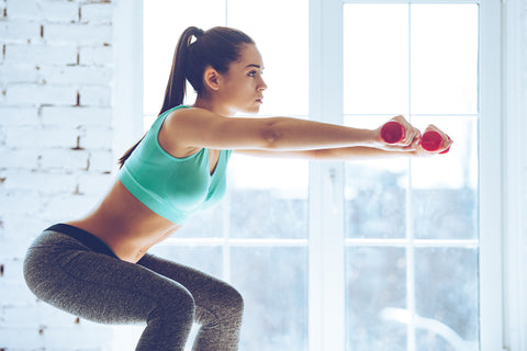 woman squatting with weights