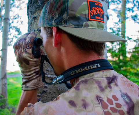 hunter holding range finder to his eye