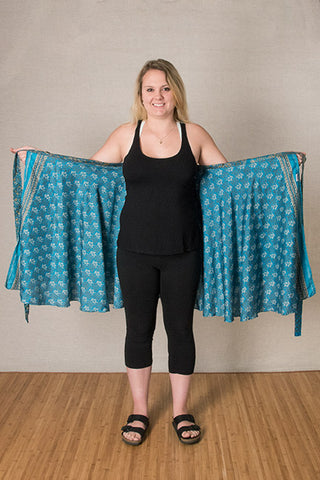 Step 1: Holding onto the straps, stretch the skirt out wide behind your back with the longer layer closest to your body.
