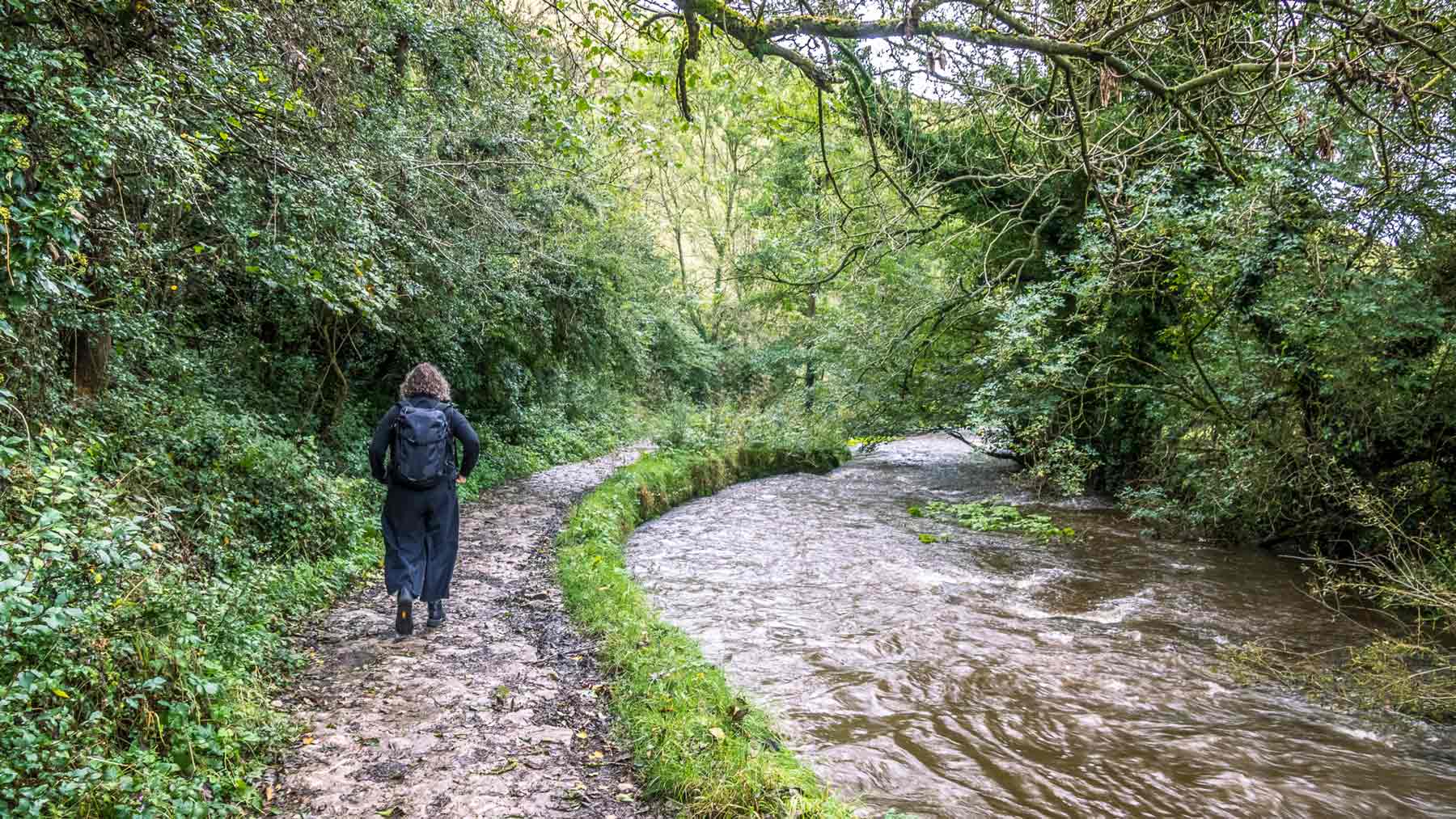 Clare, wearing Asmuss, walking alongside the River Dove