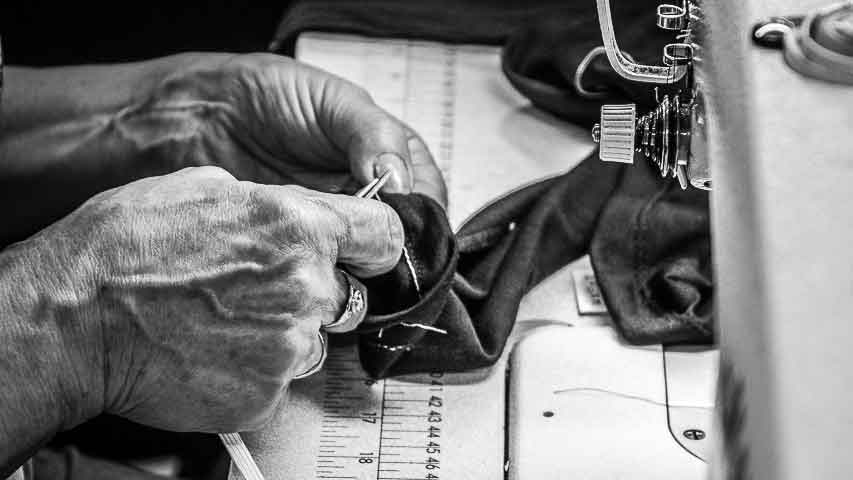 Machinist working at her sewing machine on Asmuss Geo Print Rose T-shirt