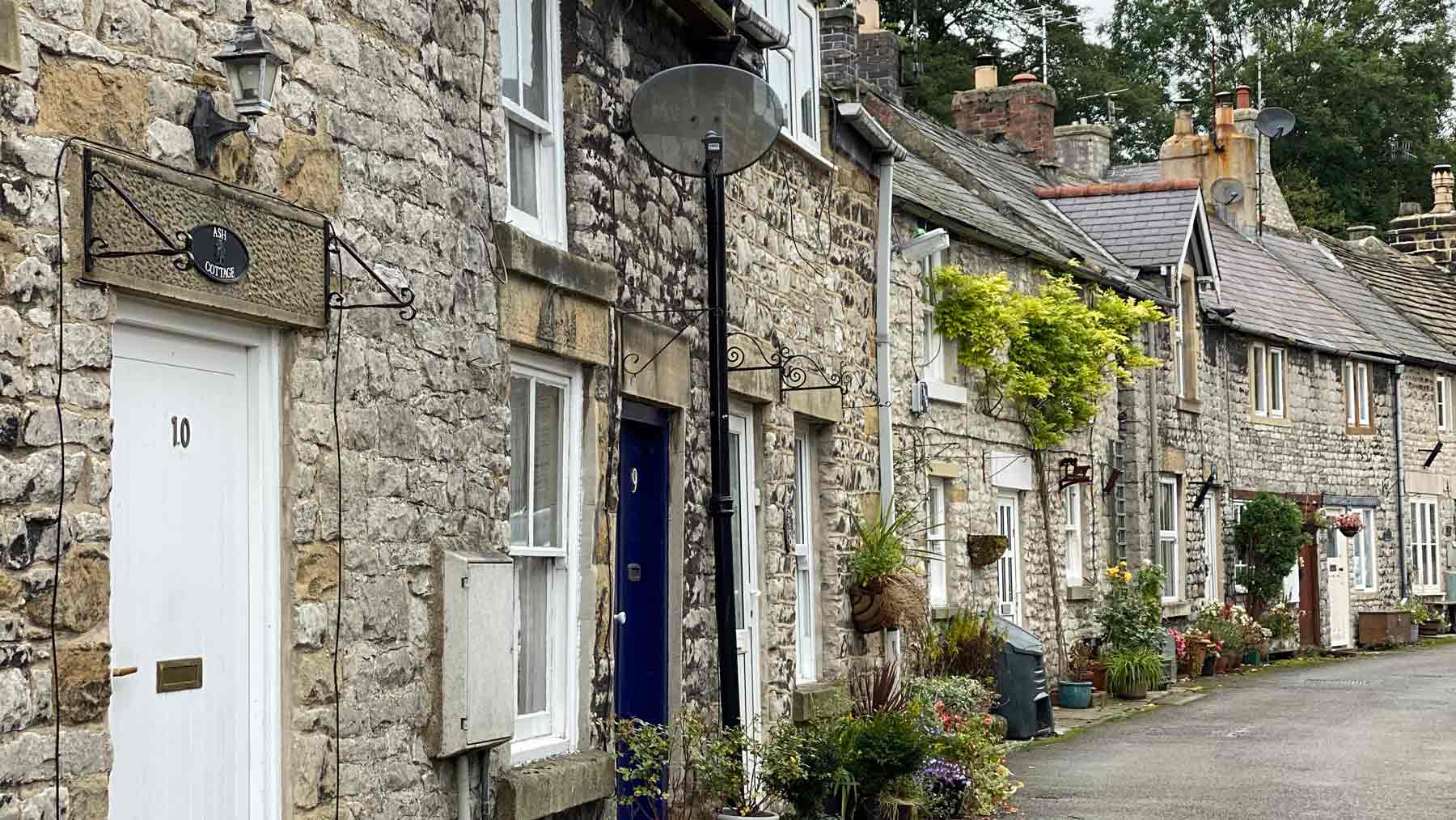 Pretty grey stone cottages in Tidewell, Peak District
