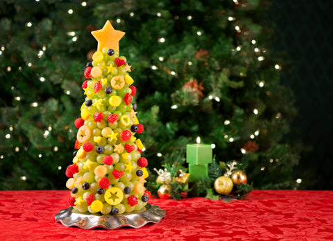 A Christmas Tree made entirely out of fruit is a healthy snack for your kids