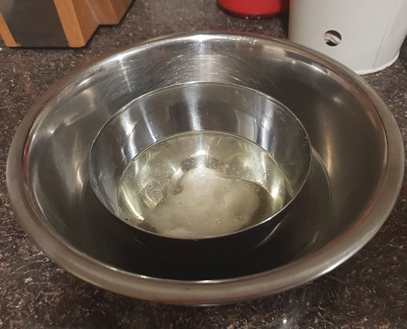 Melt coconut oil over a bowl of warm water