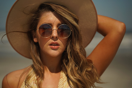 A woman wearing a brown hat and sunglasses