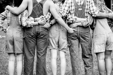 5 people in overalls in black and white photo 