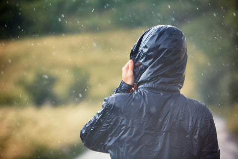A shot of a hiker in a rain jacket.