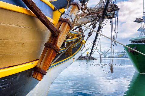 A shot alongside one of the large boats docked in Yaquina Bay, looking toward the Yaquina Bay Bridge.