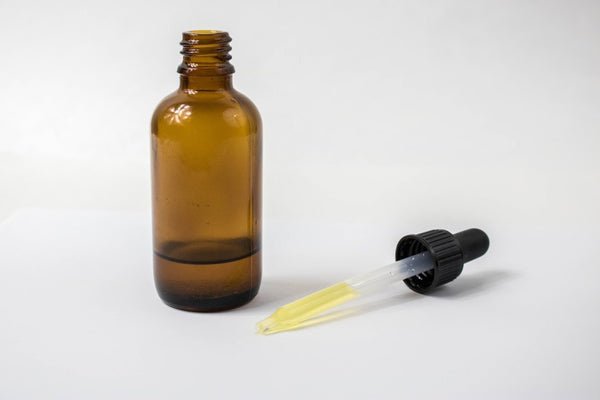 Essential oil in amber glass with a glass dropper