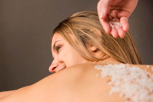 Using body scrub on back