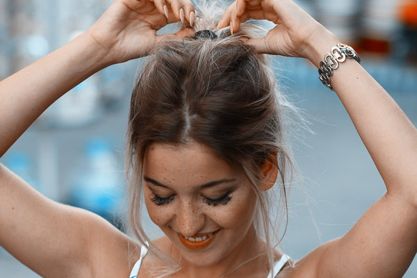 A girl tying her hair