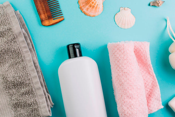 Shampoo bottle, comb, and towels